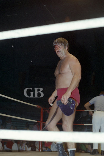 Ed Francis, bruised and battered, walks away with his Hawaiian Championship Belt after a vicious match with Vachon.