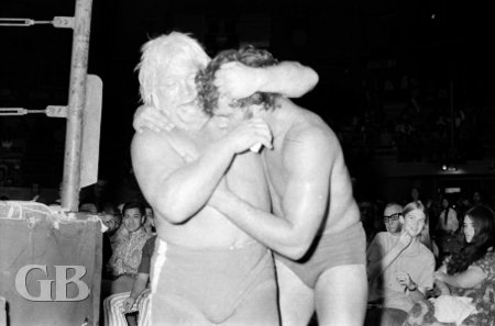 Maddog Mayne manhandles Billy Francis outside the ring