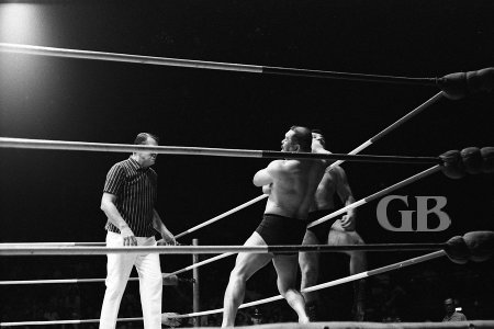 Tosh Togo levels an elbow to Jim Hady's jaw as Hady stands on the ring apron.