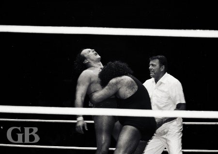 Referee Pete Peterson watches Johnny Barend carefully as the Missing Link looks for a submission with his Bear Hug.