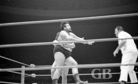 Peter Maivia about to flip Curtis Iaukea over with a side belly to belly suplex.