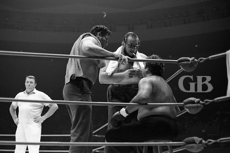 Seconds Gorilla Monsoon and Rocky Montero offer advice to Curtis Iaukea between rounds