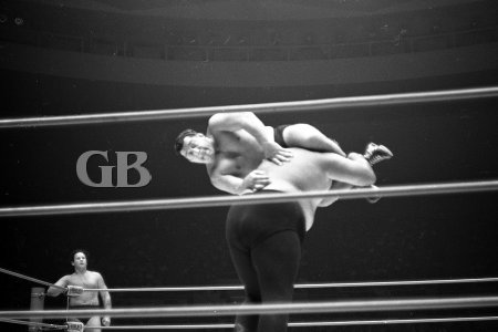 Jim Hady holds on to Curtis Iaukea's neck with a Head Scissors.