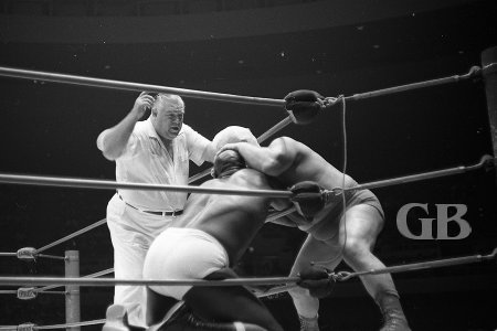 Fred Blassie takes a bite out of Bearcat Wright's forehead.